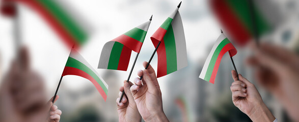 A group of people holding small flags of the Bulgaria in their hands - obrazy, fototapety, plakaty