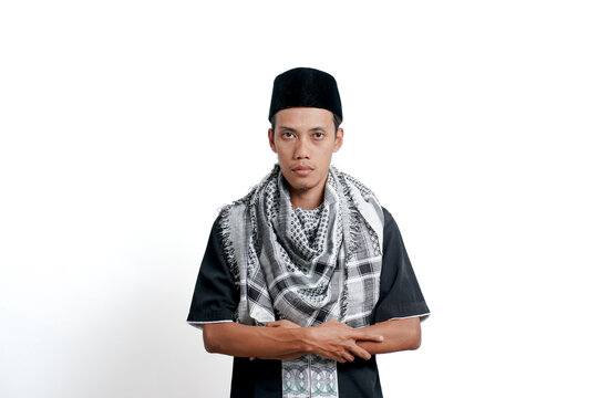 Religious muslim asian man wearing turban, muslim dress and cap. Posing crossed arms isolated on white background.