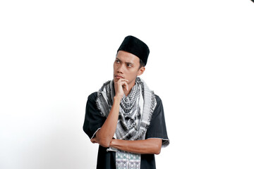 Religious muslim asian man wearing turban, muslim dress and cap, is thinking or looking for ideas. Isolated on white background.