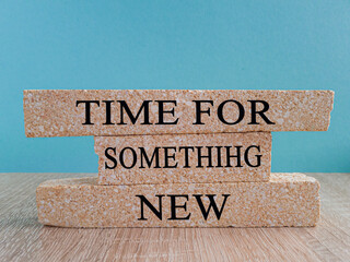 Time for something new symbol. Brick blocks with words 'Time for something new' on wooden table and...