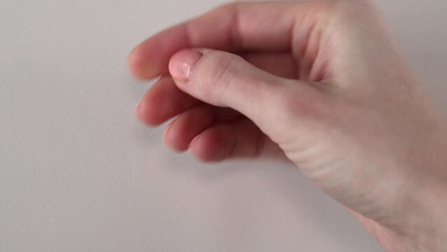 A vitamin d3 capsule in a woman's hand in close-up. Fish oil pill or vitamin D supplement.