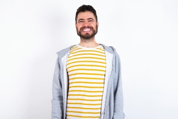 Fototapeta premium caucasian man wearing casual sportswear over white wall with a happy and cool smile on face. Lucky person.