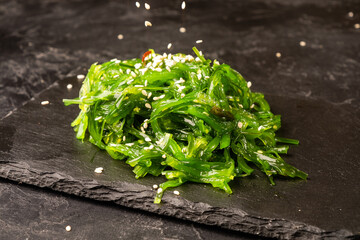 Asian seaweed chukka salad on a dark background. © Alexandr Milodan