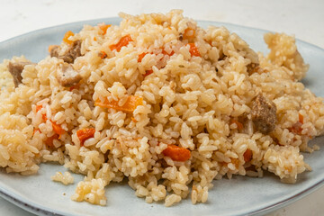 Rice with meat and vegetables close-up.