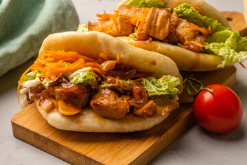 Bao buns with chicken and onions and vegetables.