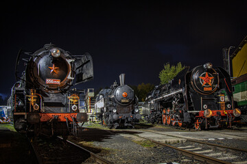 historical steam locomotives waiting at night for a new day