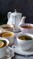 Cups of tea with lemon and mint