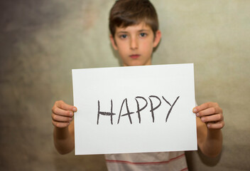 A child holding with his arms a happy message