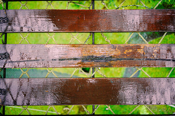 Close-down-facing view of wood bridge footing supported above steel wire and woven plastic ropes as an extra safety measure