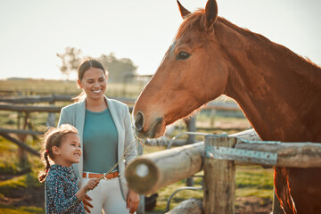 Horse feeding, girl and mother on farm with animal and smile in the countryside outdoor. Pet...
