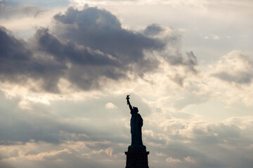 statue of liberty dramatic sky