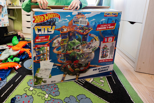 Ternopil, Ukraine - February, 2023: Kids unboxing Hot Wheels City