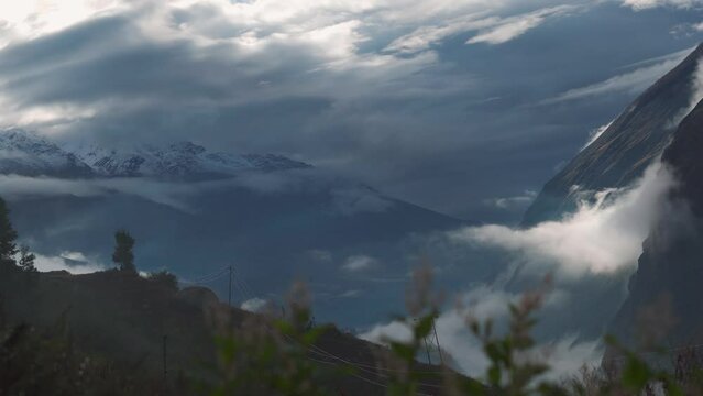 4K shot of clouds above the mountain peaks during the storm at Jispa in Lahaul Spiti district at Himachal Pradesh in India. Clouds covers the peaks of the mountains. Natural background. 