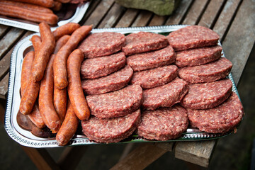 several women pieces of meat ready for barbecue
