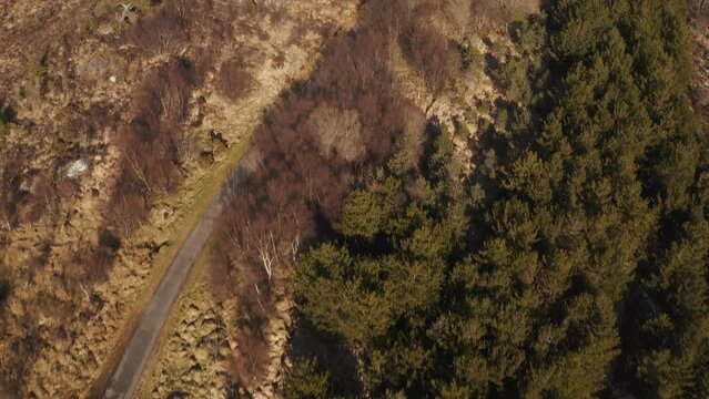Drone tilt-shot revealing the town of Stornoway and the landscape beyond it on a sunny day on the Isle of Lewis, Outer Hebrides of Scotland, United Kingdom.