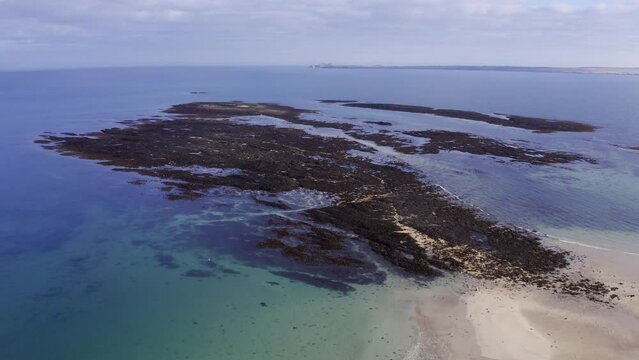 Drone shot of the islands beyond Gress beach at low tide on the Outer Hebrides of Scotland.
