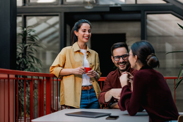 Two females talking to a businessman, during the work break.