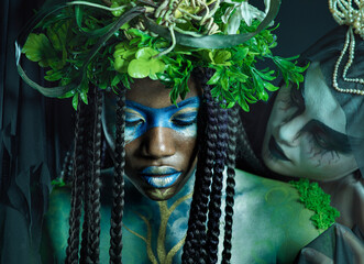 Plant, crown and fantasy with black woman and queen for evil, halloween and dark magic. Fashion, aesthetic and horror with women and creative art for beauty, danger or makeup with studio background © Courtney/peopleimages.com