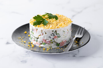 Russian salad or Olivier salad on marble table 