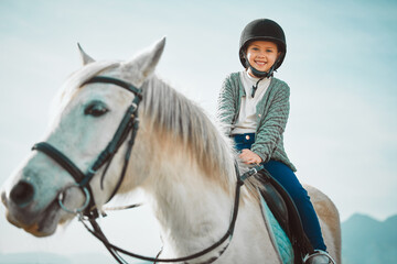 Ranch, happy and girl child on a horse to practice riding for a championship, competition or race....