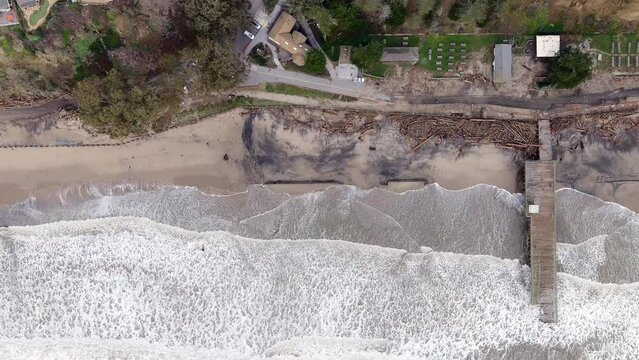 Popular Beach And Iconic Pier Destroyed By Storm In Seacliff State Beach, Aptos, California. aerial topdown, slowmo