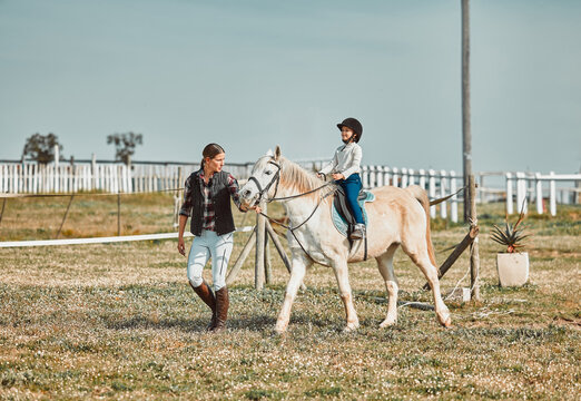 .Lesson, Help And Woman With A Child On A Horse For Learning, Sports And Hobby On A Farm In Italy. Helping, Support And Coach Teaching A Girl Horseback Riding For A Physical Activity In Countryside.