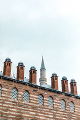 Brick chimney over the brick wall. © Sergey Lorgus