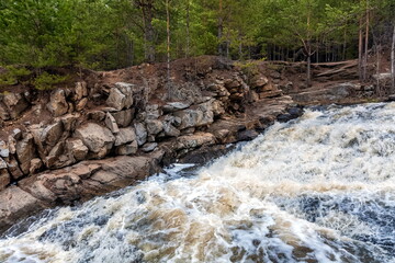 Waterfall on the river with rocky shores . Russia. Ural.