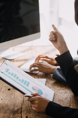 Entrepreneur Asian businessman and businesswoman discussing new business project in tablet in modern Meeting In Modern Office, Asian business casual concept.