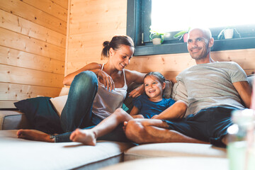 Family of three at home, watching tv together