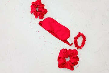 top view red accessories sleeping mask on grey background flat lay