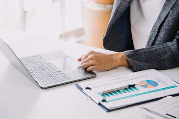 Entrepreneur Asian businessman and businesswoman discussing new business project in tablet in modern Meeting In Modern Office, Asian business casual concept.