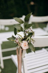 Roses Decorating a White Chair for a Wedding Ceremony, Close-up