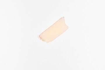 One cosmetic touch of foundation. Perfection of the skin. The concept of beauty, cosmetology and makeup. Design template, poster for advertising on light grey background. Copy space.High quality photo