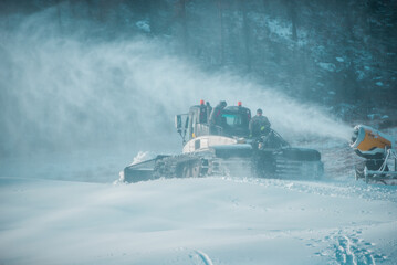 Snow-groomer machine on snow hill ready for skiing slope preparations in High Tatras, snow plow.