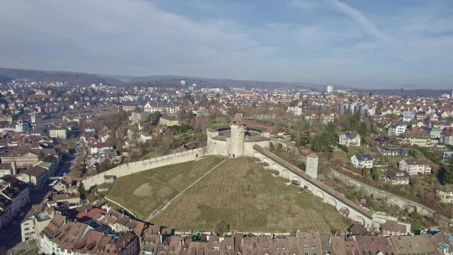Aerial 360 degree round shot Schaffhausen with famous Munot fortification on top of a hill with historic houses and vineyard. Movie shot February 16th, 2023, Schaffhausen, Switzerland.