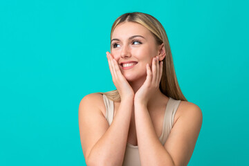 Portrait of pretty young woman over blue isolated background