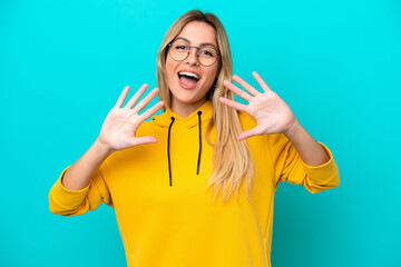 Young Uruguayan woman isolated on blue background counting ten with fingers