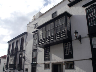 Obraz premium Typical balconies on a quiet street in Santa Cruz de La Palma with Canarian dragon tree. No people