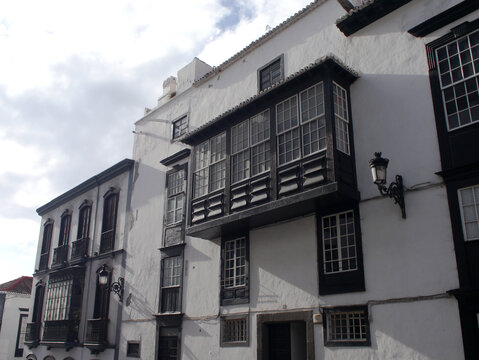 Typical balconies on a quiet street in Santa Cruz de La Palma with Canarian dragon tree. No people