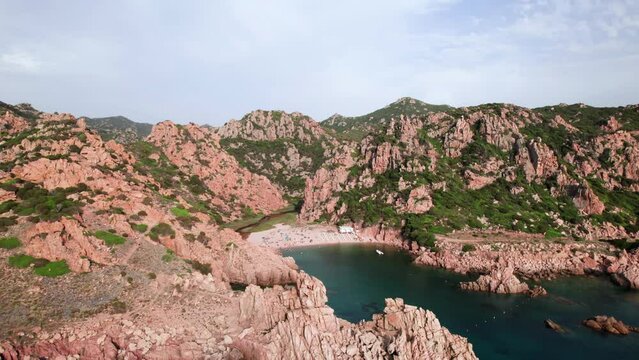 Aerial wide panorama of white sand beach in a rocky bay on Sardinia coast