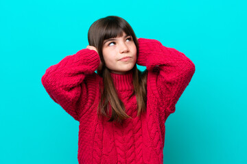 Little caucasian girl isolated on blue background frustrated and covering ears