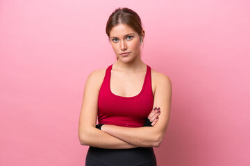 Young caucasian woman isolated on pink background with arms crossed