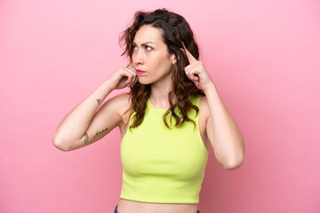 Young caucasian woman isolated on pink background having doubts and thinking