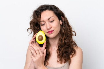 Young caucasian woman isolated on white background holding an avocado. Close up portrait