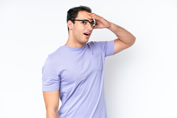 Fototapeta premium Young caucasian man isolated on white background doing surprise gesture while looking to the side