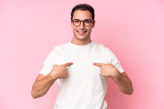 Young caucasian man isolated on pink background with surprise facial expression