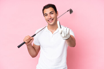 Young golfer player man isolated on pink background showing and lifting a finger