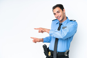 Young police caucasian man isolated on white background pointing finger to the side and presenting...