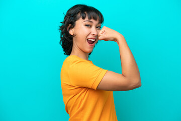 Young Argentinian woman isolated on blue background doing strong gesture